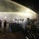 Georgia State Police pushes back protesters with water cannons as they try to ramble into the presidential palace