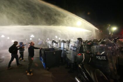 Georgia State Police pushes back protesters with water cannons as they try to ramble into the presidential palace