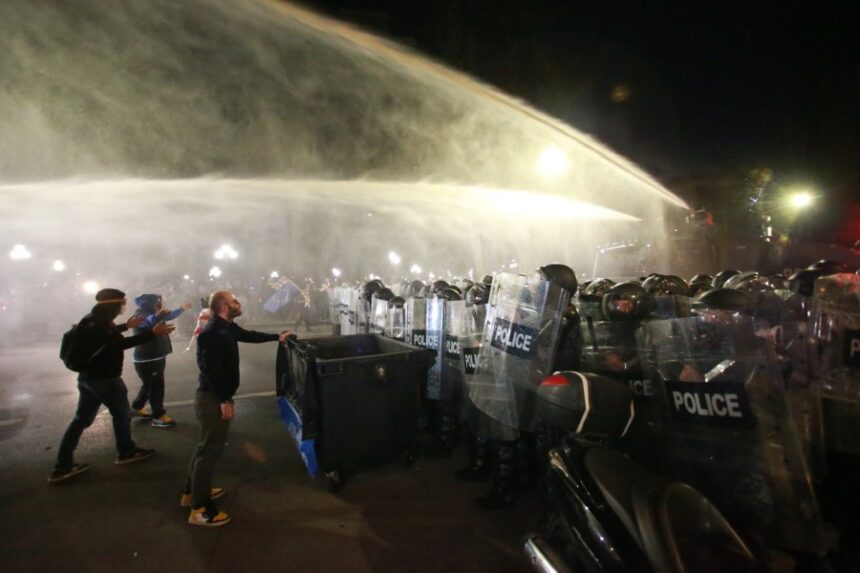Georgia State Police pushes back protesters with water cannons as they try to ramble into the presidential palace