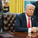 President Trump sitting at desk in Oval Office