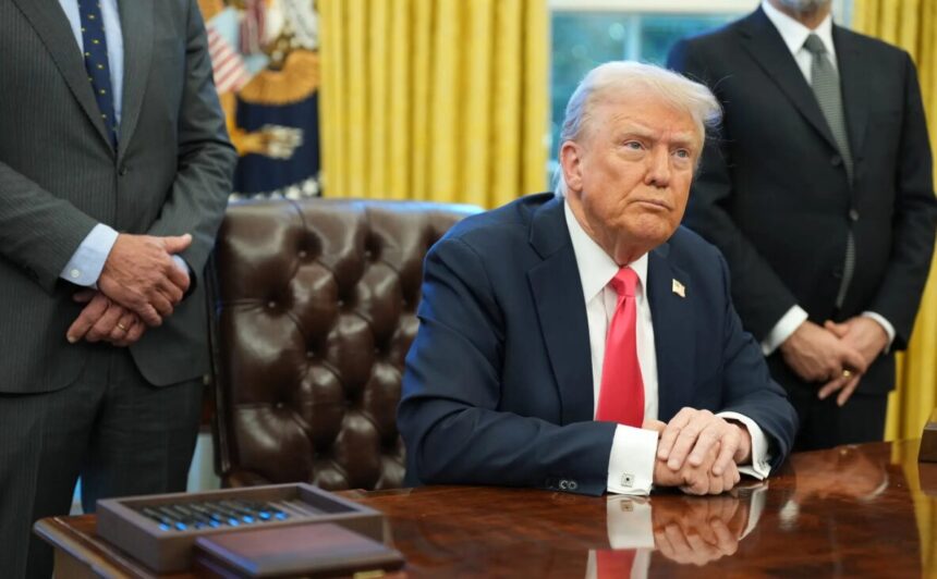 President Trump sitting at desk in Oval Office