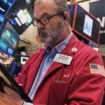 Stock market hits record high as concerns about AI bubble persist